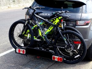 electric bikes mounted to the back of car with rack