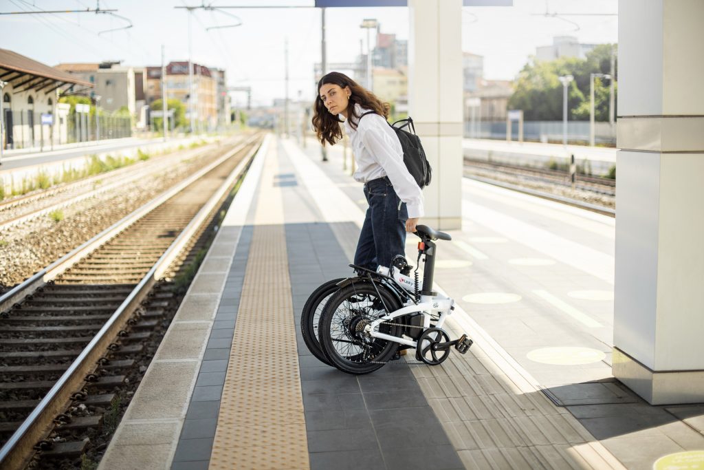 girl waiting for the train with the foldable electric bike Ezy Fold